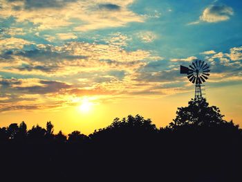 Low angle view of silhouette trees against sky during sunset