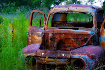 Abandoned car on field