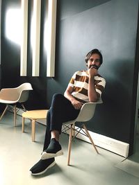 Young man sitting on chair at home