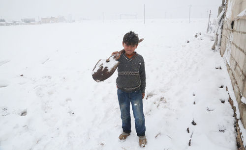 Syrian refugee children playing in the snow that fell on the camp near the syrian-turkish border.