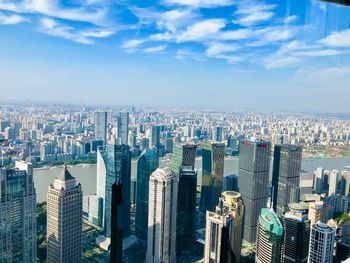 High angle view of modern buildings in city against sky