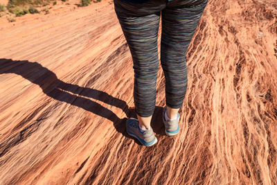 Athletic shoes walking along a rock formation in the desert