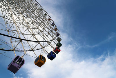 Low angle view of ferris wheel against sky