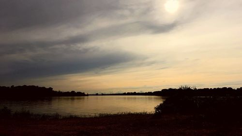 Scenic view of lake against sky during sunset
