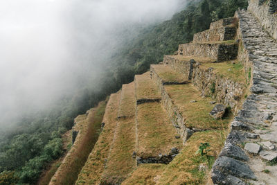 Old stairs under thick fog in machu picchu