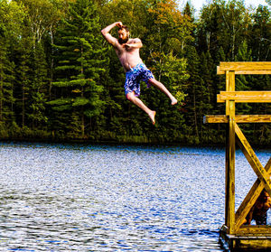 Mid adult man diving into lake