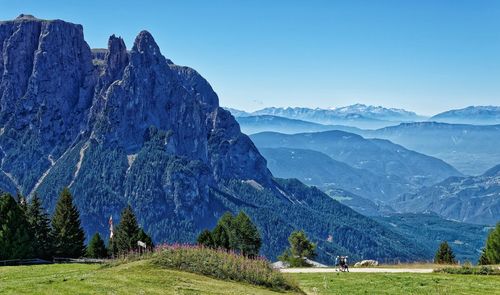 Scenic view of mountains against blue sky