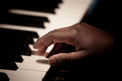 Close-up of hands playing piano