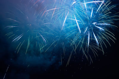 Low angle view of fireworks in sky at night