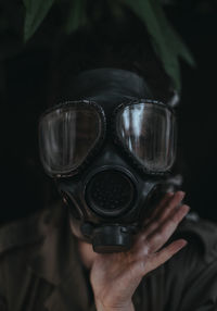 Portrait of woman wearing gas mask