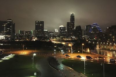 Illuminated cityscape against sky at night