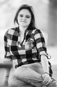 Portrait of smiling woman sitting outdoors