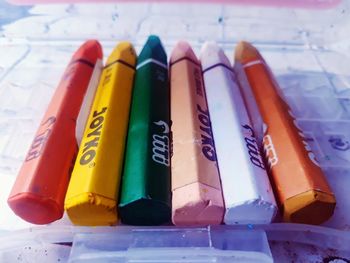 Close-up of multi colored pencils in row