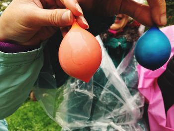 Close-up of person holding colorful balloons