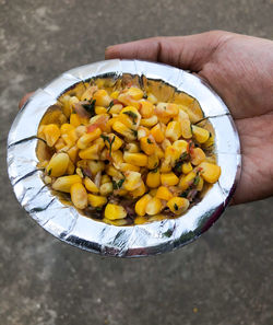 High angle view of person holding yellow food