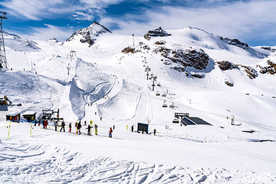 People skiing on snowcapped mountain