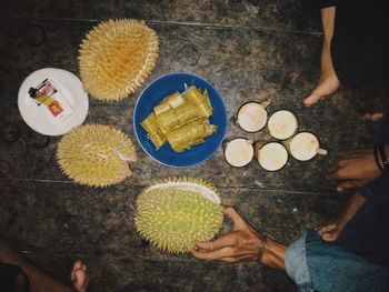 High angle view of hands holding food on table