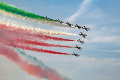 Low angle view of airshow against sky