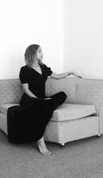 Full length of woman sitting on bench