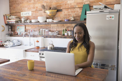 Businesswoman working on her laptop from home