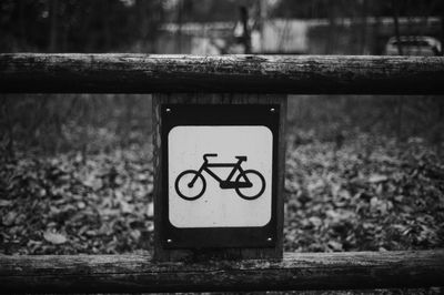 Close-up of sign on railing