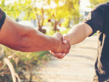 Midsection of man holding hands