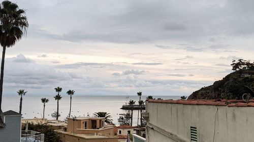 High angle view of buildings and sea against sky