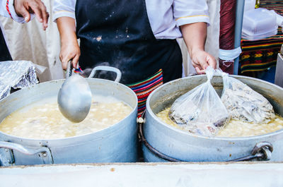 Midsection of man preparing food at market