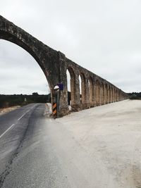 Bridge over road against sky