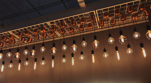 Illuminated lights hanging from the ceiling, revealing an inspiring photograph