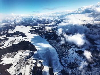 Aerial view of snowcapped mountains against sky