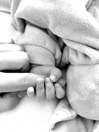 Close-up of mother holding baby hand