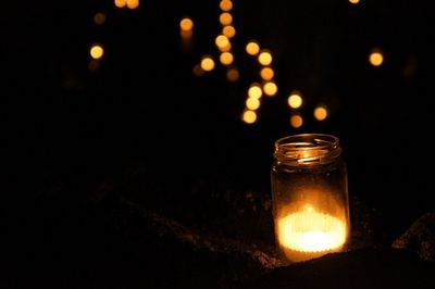 Close-up of illuminated candles on table