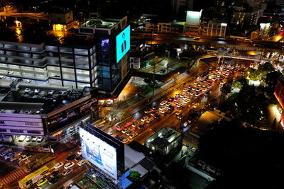 High angle view of illuminated street amidst buildings in city