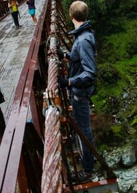 Man standing on tree trunk