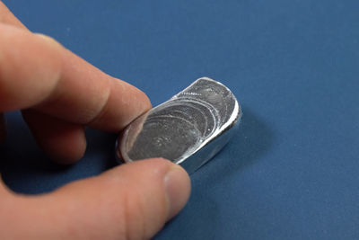 Close-up of human hand holding metal