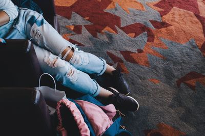 Low section of woman standing on tiled floor