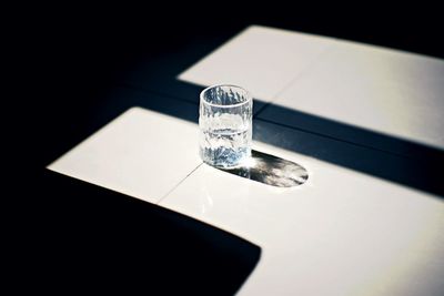 High angle view of cigarette on table against black background