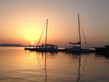 Sailboat in sea at sunset