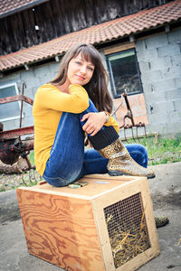 Young woman smiling while sitting outdoors