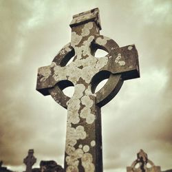 Low angle view of old church against cloudy sky