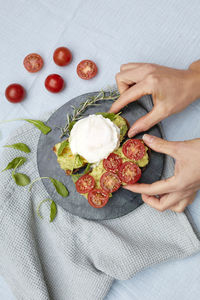 Cropped hands of woman holding food on table