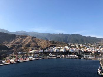 City by sea against clear blue sky