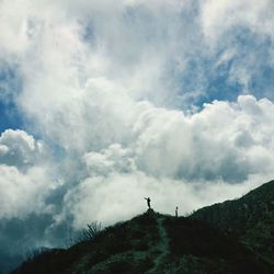 Scenic view of mountains against cloudy sky