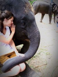 Woman touching elephant