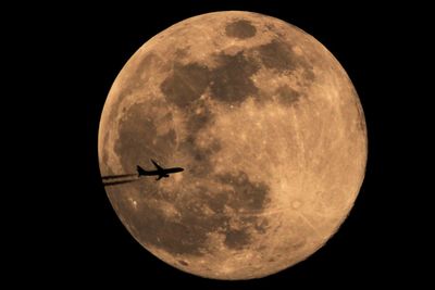 Low angle view of moon against sky at night