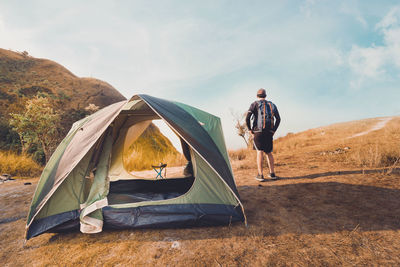 Wanderlust and relax in nature with hiker man camping on top of mountain on spring and summer season