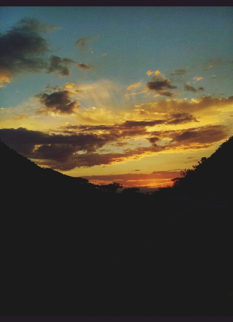 sunset, silhouette, scenics, tranquil scene, sky, beauty in nature, tranquility, cloud - sky, mountain, nature, idyllic, landscape, orange color, cloud, dark, dramatic sky, dusk, majestic, outdoors, mountain range