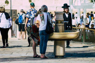 Group of people walking on footpath