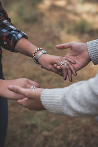 Cropped image of couple holding hands